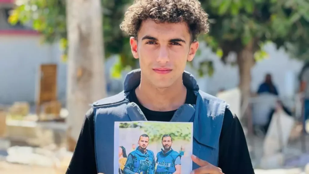 Hassan Hamad, 19 years old, killed by an IOF air strike. Seen holding a photo of the late Ismail al-Ghoul and late Rami Al Refee.