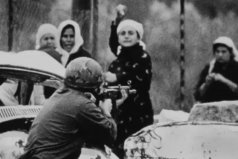 Palestinian woman with rock vs IOF terrorist with a rifle during First Intifada